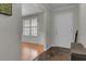 Hallway with hardwood floors, wainscoting, and natural light from a nearby window at 1205 Scotch Pine Ln, Ladson, SC 29456