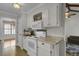 Well-lit kitchen featuring white cabinets, modern appliances, and a view into the living room at 1205 Scotch Pine Ln, Ladson, SC 29456