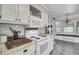White kitchen cabinets and countertops with modern appliances, and a view into the breakfast nook at 1205 Scotch Pine Ln, Ladson, SC 29456