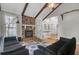 Open-concept living room with stone fireplace, hardwood floors, and access to other rooms at 1205 Scotch Pine Ln, Ladson, SC 29456