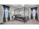 Stylish bedroom with a canopy bed, patterned curtains, and bedside tables at 1205 Scotch Pine Ln, Ladson, SC 29456