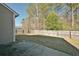 Wide fenced backyard with a concrete patio and partial view of the house siding at 122 Rockingham Way, Moncks Corner, SC 29461