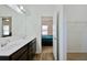 Bathroom features a double sink vanity with modern fixtures and a view into the adjacent bedroom at 122 Rockingham Way, Moncks Corner, SC 29461