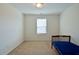 Bright bedroom with neutral carpet, a window providing natural light, and a dark-wood-framed bed at 122 Rockingham Way, Moncks Corner, SC 29461