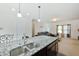Open concept kitchen with island, stainless steel sink, and view to the living room at 122 Rockingham Way, Moncks Corner, SC 29461