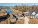 Aerial view of a well-maintained home with lush lawn, long driveway and a backyard pool nearby at 130 Darby Mdw Ln, Ridgeville, SC 29472