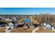 An aerial view of the community showcasing the home with a pond, manicured lawns, and neighborhood setting at 130 Darby Mdw Ln, Ridgeville, SC 29472
