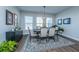 Elegant dining area with a wooden table, upholstered chairs, and modern chandelier at 130 Darby Mdw Ln, Ridgeville, SC 29472