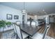 The dining room features an elegant table set for six and modern lighting with a view into the kitchen at 130 Darby Mdw Ln, Ridgeville, SC 29472