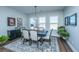 Bright dining room features hardwood floors, decorative rug, and elegant table set for six at 130 Darby Mdw Ln, Ridgeville, SC 29472