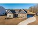 Beautiful home with a concrete driveway, manicured lawn, and an elegant stone and siding facade at 130 Darby Mdw Ln, Ridgeville, SC 29472