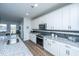 Well-lit kitchen features granite countertops, stainless steel appliances and a view into the dining area at 130 Darby Mdw Ln, Ridgeville, SC 29472