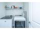 Bright laundry room featuring modern Maytag washer and dryer and convenient overhead storage shelf at 130 Darby Mdw Ln, Ridgeville, SC 29472