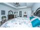 Comfortable main bedroom features a tray ceiling, ceiling fan and private ensuite bathroom at 130 Darby Mdw Ln, Ridgeville, SC 29472
