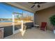 Charming screened porch with a ceiling fan, offering a serene view of the pond and backyard at 130 Darby Mdw Ln, Ridgeville, SC 29472