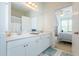 Bathroom featuring double sinks, large mirrors, and easy access to an adjacent bedroom at 130 River Landing Dr # 6207, Charleston, SC 29492