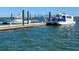 Water view featuring a dock and a boat, with a clear blue sky and calm water at 130 River Landing Dr # 6207, Charleston, SC 29492
