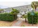 Community grilling area with a private property sign, lush landscaping and a view of the water fountain at 130 River Landing Dr # 6207, Charleston, SC 29492
