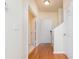 Inviting hallway with hardwood floors, neutral walls, and white doors leading to various rooms of the home at 130 River Landing Dr # 6207, Charleston, SC 29492