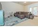 Comfortable living room featuring a large sectional sofa, stylish rug, and ample natural light from the doorway at 130 River Landing Dr # 6207, Charleston, SC 29492