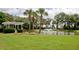 Picturesque pond with a fountain and a gazebo surrounded by a green lawn and mature trees at 130 River Landing Dr # 6207, Charleston, SC 29492