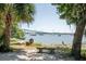Relaxing water view featuring a concrete bench, calm water, boats and palm trees at 130 River Landing Dr # 6207, Charleston, SC 29492