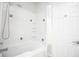 Clean white bathtub and shower with tiled walls, corner shelves, and a shower curtain at 130 River Landing Drive # 8209, Charleston, SC 29492