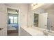 Bathroom with dual sinks, a large mirror, and a view into the adjacent bedroom at 130 River Landing Drive # 8209, Charleston, SC 29492