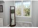 Bright bedroom with large windows and a full-length mirror at 130 River Landing Drive # 8209, Charleston, SC 29492