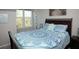 Bright bedroom with a large window, stylish furnishings, and a comfortable bed with patterned bedding at 130 River Landing Drive # 8209, Charleston, SC 29492