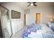 Inviting bedroom with a decorative mirror, flat screen TV, and easy access to other rooms at 130 River Landing Drive # 8209, Charleston, SC 29492