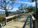 Picturesque boardwalk featuring a wooden walkway with views of the marsh, boats, and a loading crane in the background at 130 River Landing Drive # 8209, Charleston, SC 29492