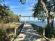 Scenic boardwalk featuring a wooden walkway with views of the river, boats, and a bridge in the background at 130 River Landing Drive # 8209, Charleston, SC 29492