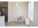 Bright dining area features a modern table, stylish lighting, and a stainless steel refrigerator at 130 River Landing Drive # 8209, Charleston, SC 29492