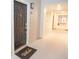 Exterior view of a front door with a 'Welcome' mat leading into a bright hallway with unit number at 130 River Landing Drive # 8209, Charleston, SC 29492