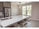 Bright kitchen features stainless steel appliances, gray cabinetry, white countertops, and a breakfast bar with seating at 130 River Landing Drive # 8209, Charleston, SC 29492