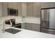 Kitchen with stainless appliances, sleek cabinetry, quartz countertops, and herringbone backsplash at 130 River Landing Drive # 8209, Charleston, SC 29492