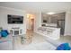 Stylish living room with open kitchen area featuring stainless steel appliances, gray cabinetry, and a breakfast bar at 130 River Landing Drive # 8209, Charleston, SC 29492