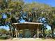 Scenic shot of an outdoor pavilion with seating, surrounded by trees, parking, and a lawn at 130 River Landing Drive # 8209, Charleston, SC 29492