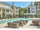 Community pool with lounge chairs and landscaped surroundings on a sunny day at 130 River Landing Drive # 8209, Charleston, SC 29492
