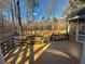Backyard featuring a wood deck with a black railing and the yard with mature trees and a fence at 132 Hidden Fawn Cir, Goose Creek, SC 29445