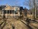 Large backyard with seating area, swing set, mature trees, and home exterior at 132 Hidden Fawn Cir, Goose Creek, SC 29445