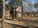 Spacious backyard featuring mature trees, a swing set, and a peaceful setting at 132 Hidden Fawn Cir, Goose Creek, SC 29445
