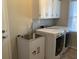 Functional laundry room featuring modern washer and dryer, sink, and storage cabinets at 132 Hidden Fawn Cir, Goose Creek, SC 29445