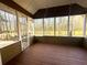 Bright screened porch with wood flooring looks out over a fenced yard and mature trees at 132 Hidden Fawn Cir, Goose Creek, SC 29445