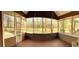 Spacious screened porch with wood flooring and a view of the fenced backyard with mature trees at 132 Hidden Fawn Cir, Goose Creek, SC 29445