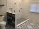 Modern shower with mixed pattern tiles, two shower heads, and a window with white blinds at 132 Hidden Fawn Cir, Goose Creek, SC 29445