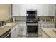 Modern kitchen with stainless steel appliances, stone countertops, and white cabinetry for a clean look at 138 Golfview Ln, Summerville, SC 29485