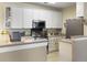 Bright kitchen featuring stainless steel appliances, white cabinetry, and a functional breakfast bar at 138 Golfview Ln, Summerville, SC 29485