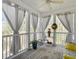 Charming screened porch with neutral curtains and ceiling fan offering an inviting outdoor living space at 138 Golfview Ln, Summerville, SC 29485